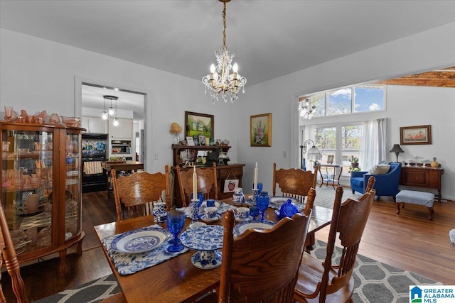 dining room with an inviting chandelier and wood finished floors