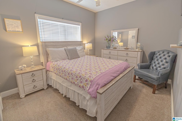 bedroom featuring a ceiling fan, light carpet, and baseboards