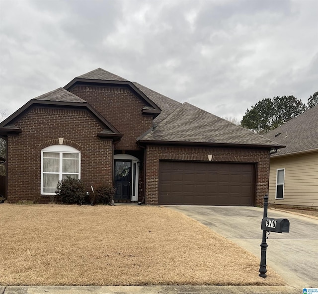 view of front of house featuring a garage, brick siding, driveway, and a shingled roof