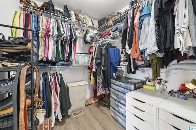 walk in closet with visible vents and light wood finished floors