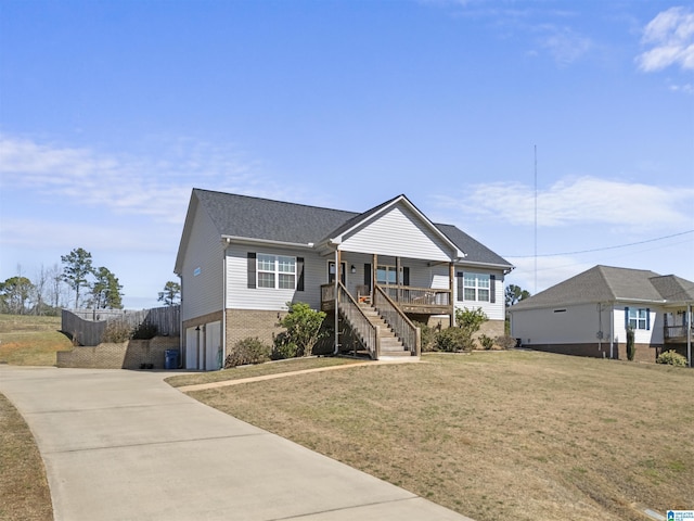 view of front of property featuring a front yard, an attached garage, stairs, concrete driveway, and brick siding