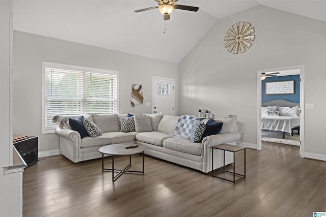 living room featuring baseboards, high vaulted ceiling, dark wood-style floors, and a ceiling fan