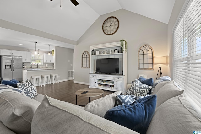 living area with baseboards, visible vents, high vaulted ceiling, dark wood finished floors, and ceiling fan