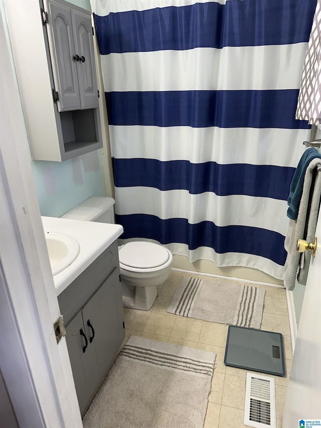 bathroom with visible vents, a shower with shower curtain, toilet, vanity, and tile patterned flooring