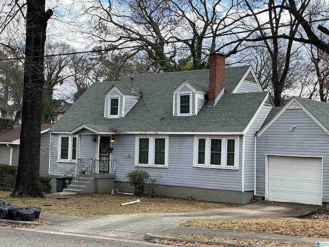 cape cod home with a garage, concrete driveway, roof with shingles, and a chimney