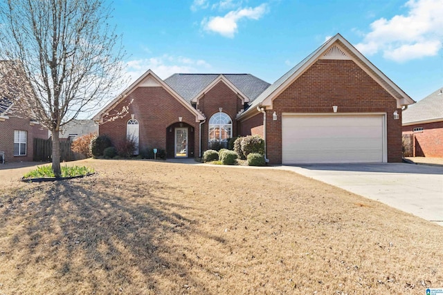 view of front of home with driveway, a garage, and brick siding