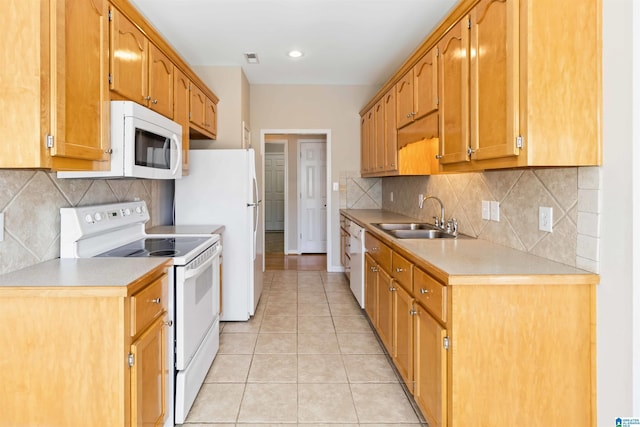 kitchen with light tile patterned floors, light countertops, decorative backsplash, a sink, and white appliances