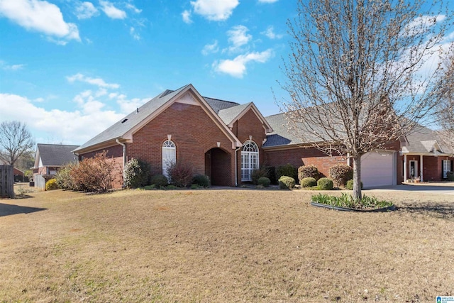 single story home with a garage, driveway, brick siding, and a front yard