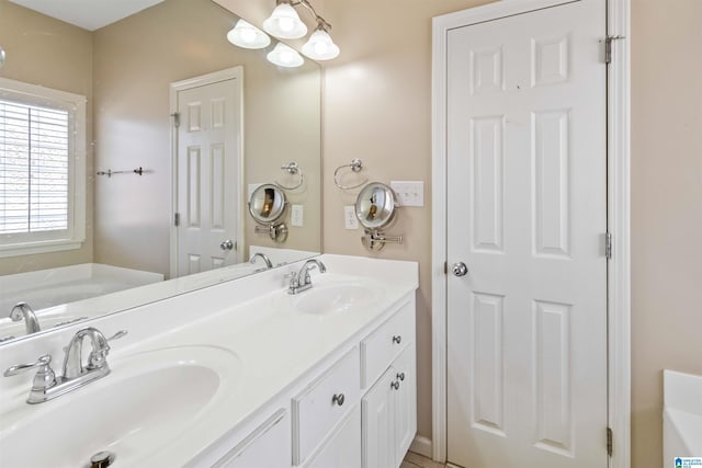 full bathroom with a garden tub, double vanity, and a sink