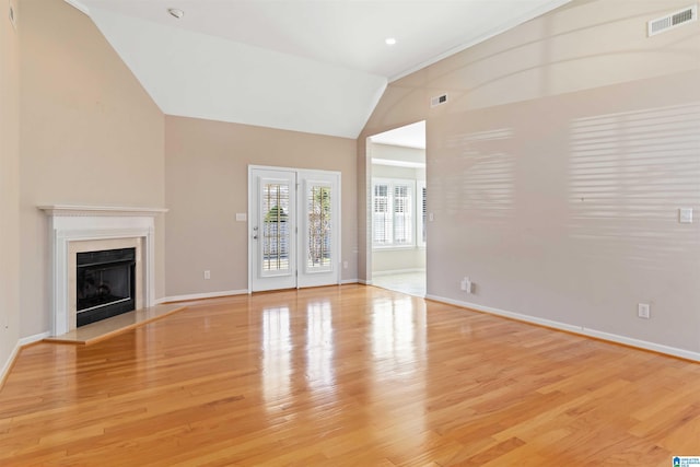 unfurnished living room featuring recessed lighting, visible vents, a fireplace with raised hearth, light wood-style flooring, and baseboards