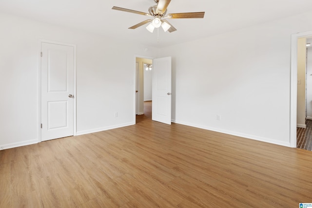 unfurnished room featuring light wood finished floors, a ceiling fan, and baseboards