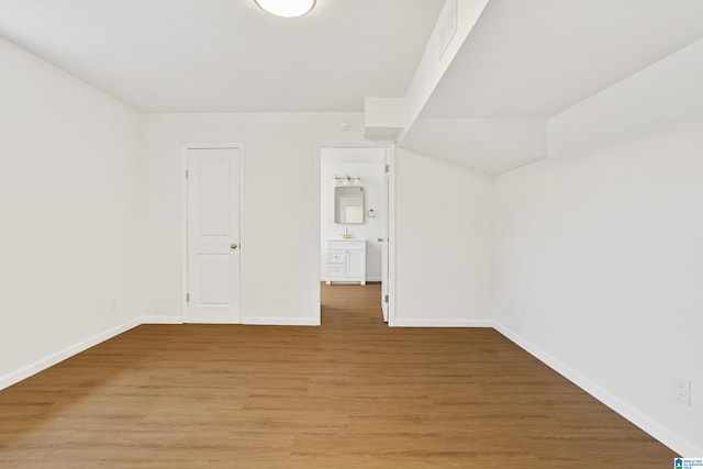 unfurnished room with light wood-style floors and baseboards