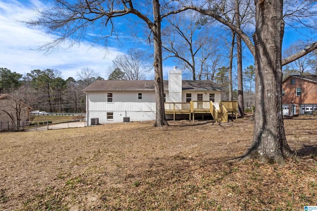 back of property with a deck, fence, a chimney, and central AC unit