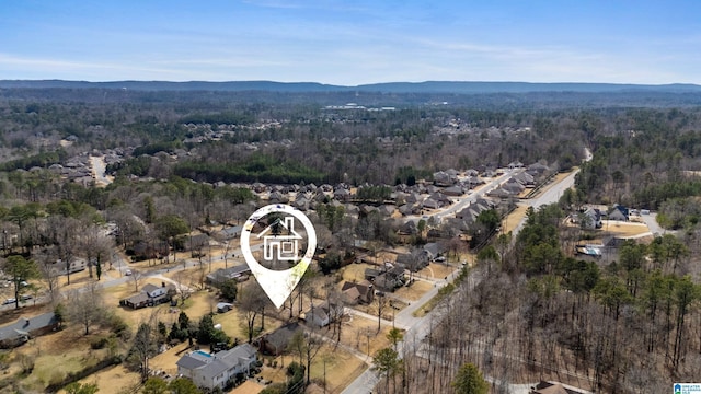 birds eye view of property with a forest view