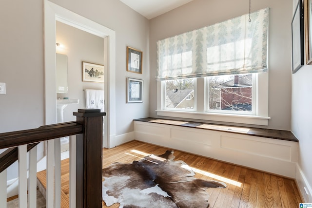 interior space featuring light wood-type flooring and baseboards