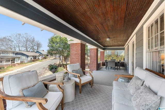 view of patio with a residential view, an outdoor living space, and a porch