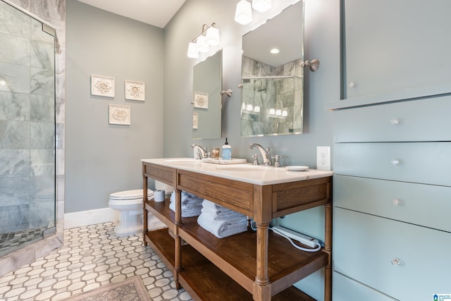 full bathroom with a shower stall, toilet, baseboards, and a sink