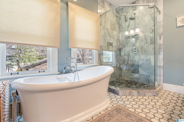 full bath with a freestanding tub and a shower stall