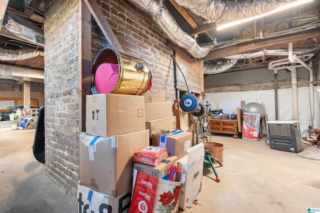 unfinished basement featuring brick wall