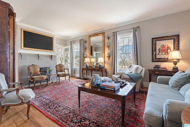 living room featuring a brick fireplace, wood finished floors, and ornamental molding