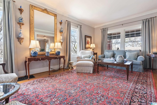 living area featuring crown molding, wood finished floors, visible vents, and baseboards