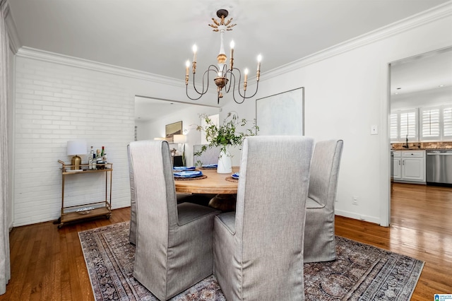 dining room featuring an inviting chandelier, wood-type flooring, and ornamental molding