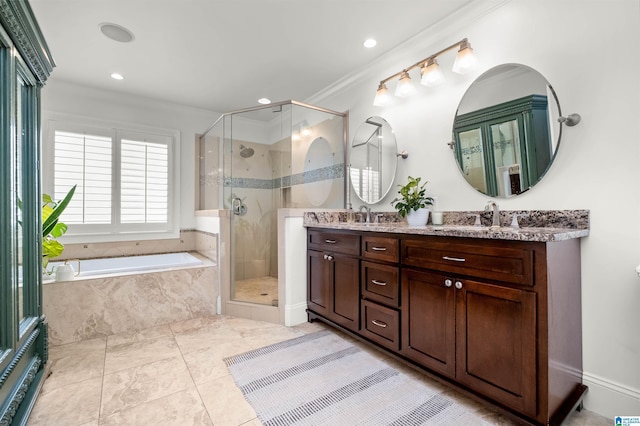 bathroom featuring a shower stall, a bath, double vanity, and a sink