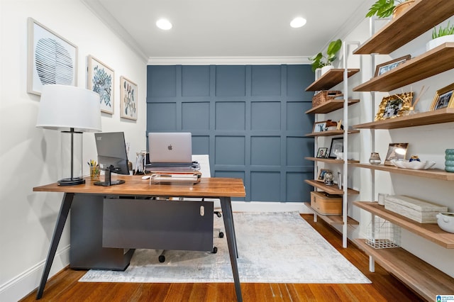 office space featuring a decorative wall, recessed lighting, crown molding, and wood finished floors