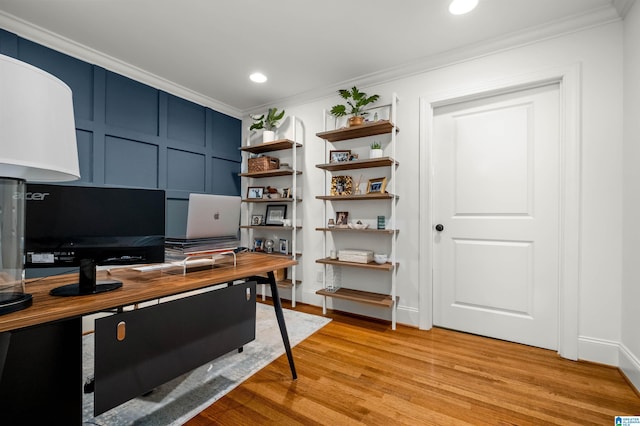 office with light wood-type flooring, ornamental molding, recessed lighting, a decorative wall, and baseboards