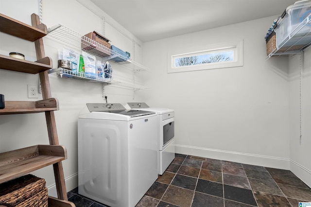 laundry area featuring baseboards, washing machine and dryer, and laundry area