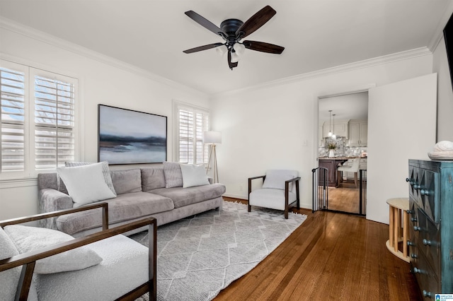 living room with ceiling fan, baseboards, dark wood-style flooring, and ornamental molding