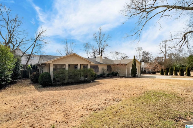 single story home featuring a chimney