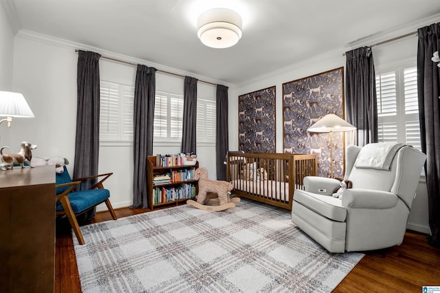 bedroom with multiple windows, wood finished floors, and crown molding