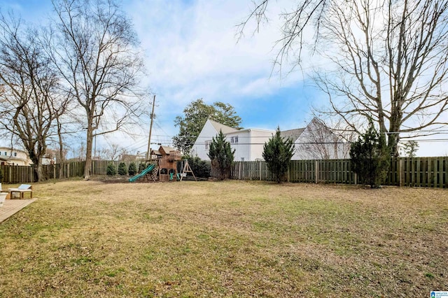 view of yard featuring a fenced backyard and a playground