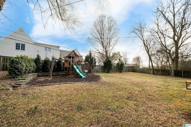 view of yard with a playground and a fenced backyard