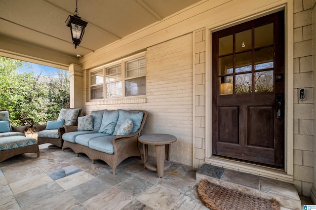 entrance to property with brick siding and outdoor lounge area