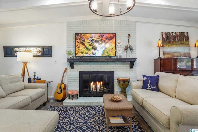 living room with lofted ceiling with beams, a fireplace, and wood finished floors