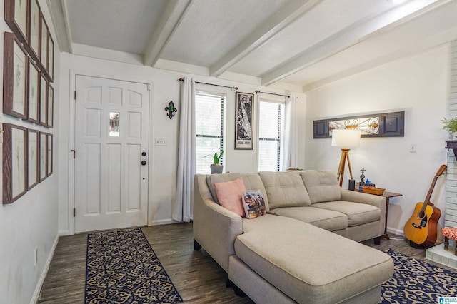 living area with dark wood finished floors, beamed ceiling, and baseboards