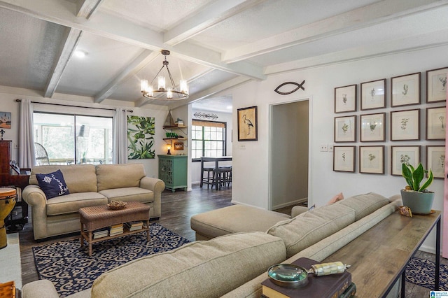 living room featuring a chandelier, lofted ceiling with beams, baseboards, and wood finished floors