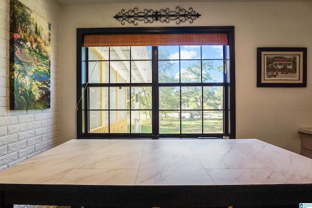 doorway to outside featuring marble finish floor