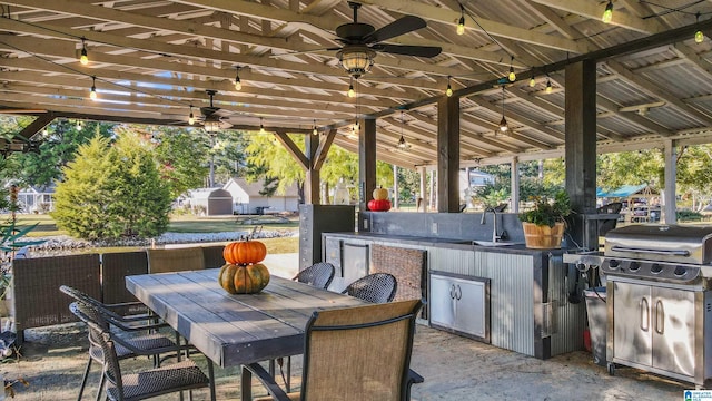 view of patio / terrace with ceiling fan, outdoor dining area, area for grilling, and a sink