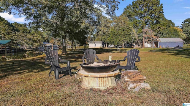 view of yard featuring an outdoor fire pit