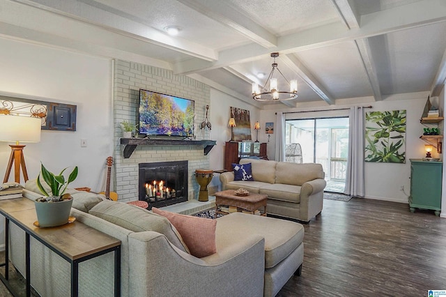 living area with a fireplace, lofted ceiling with beams, a textured ceiling, wood finished floors, and a chandelier