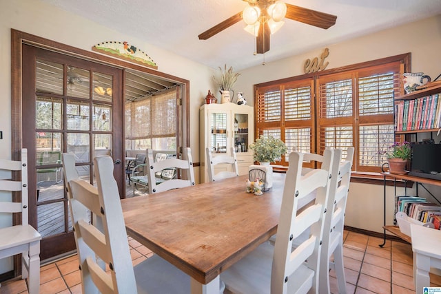 dining room featuring a ceiling fan, a textured ceiling, and light tile patterned floors