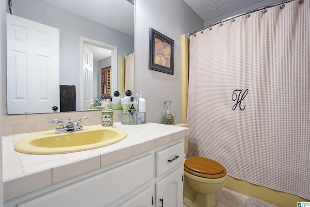 bathroom featuring toilet, tile patterned floors, vanity, and a shower with curtain