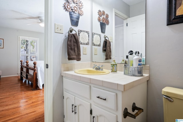 bathroom featuring vanity, wood finished floors, and a ceiling fan