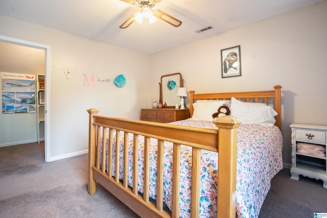 carpeted bedroom with a ceiling fan, visible vents, and baseboards