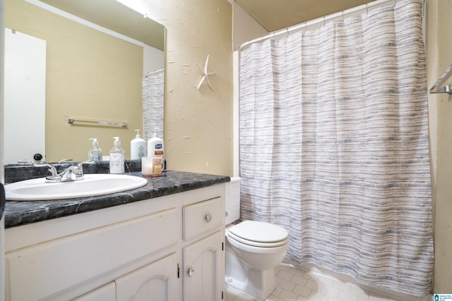 bathroom featuring toilet, a shower with curtain, tile patterned flooring, and vanity