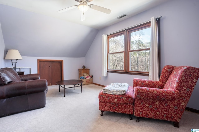 living area with baseboards, visible vents, a ceiling fan, lofted ceiling, and carpet floors