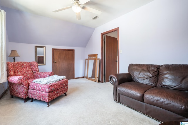 living room with lofted ceiling, visible vents, a ceiling fan, and light colored carpet